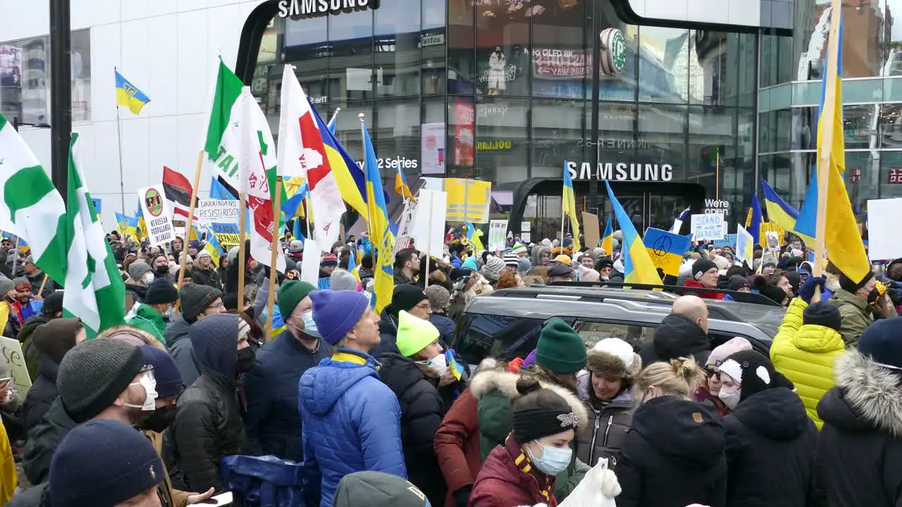 Protestors gather and wave flags to show support for Ukraine