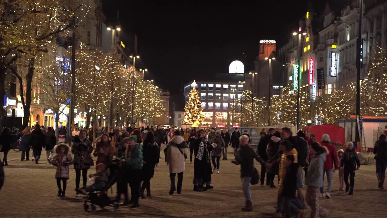 Christmas markets in decorated Prague at night with crowds of people