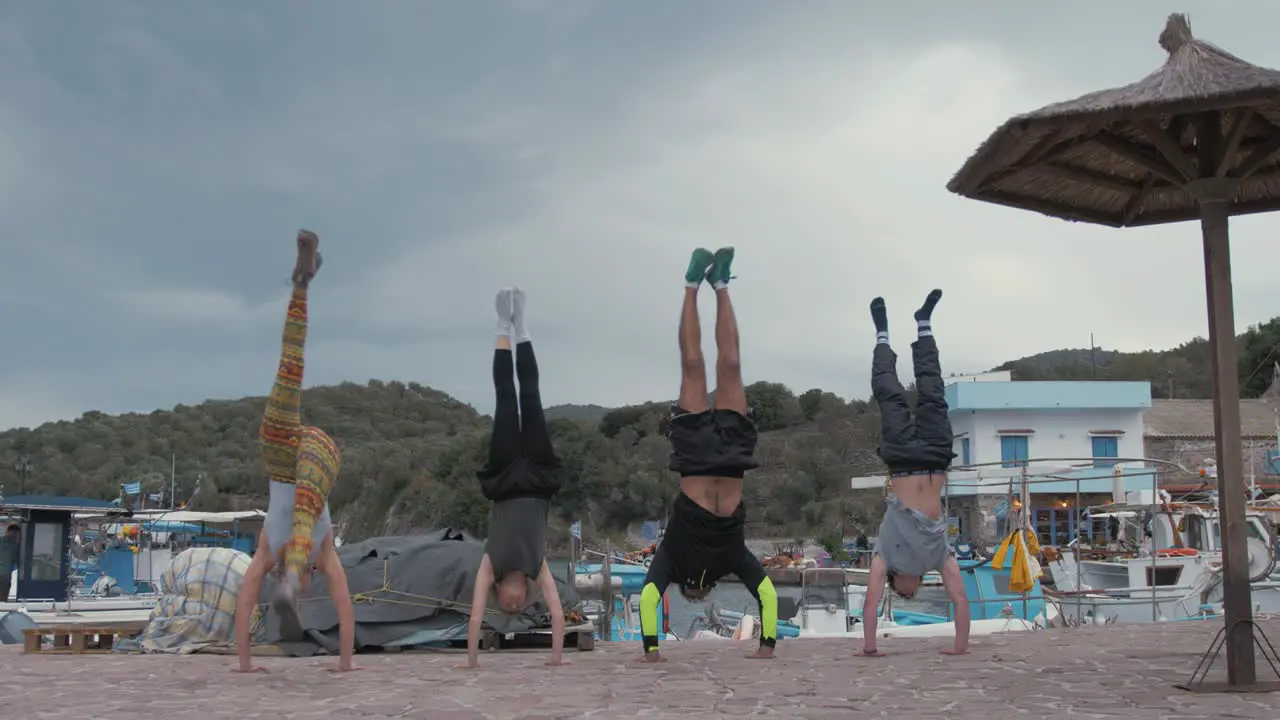 A group of friends practising their hand standing skills