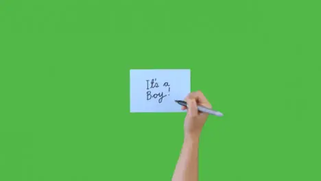 Woman Writing Its a Boy on Paper with Green Screen