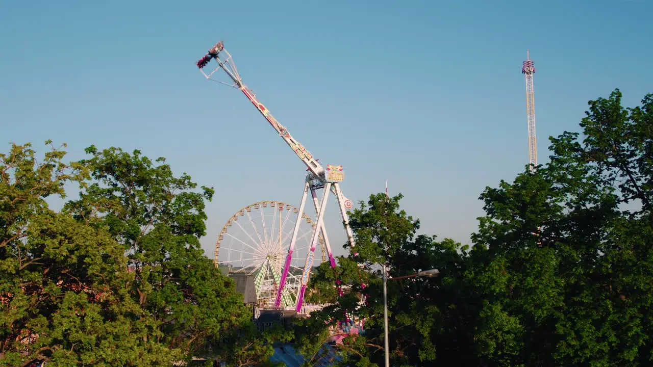 Swing Ride Ferris Wheel and Free Fall Tower Scenic overview on a clear sunny day