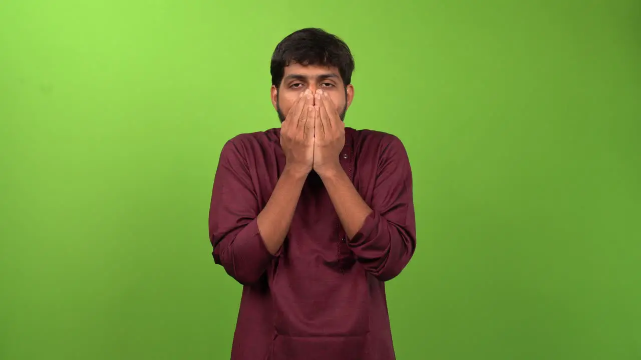 Young attractive man feeling amazement while looking at camera isolated on green screen