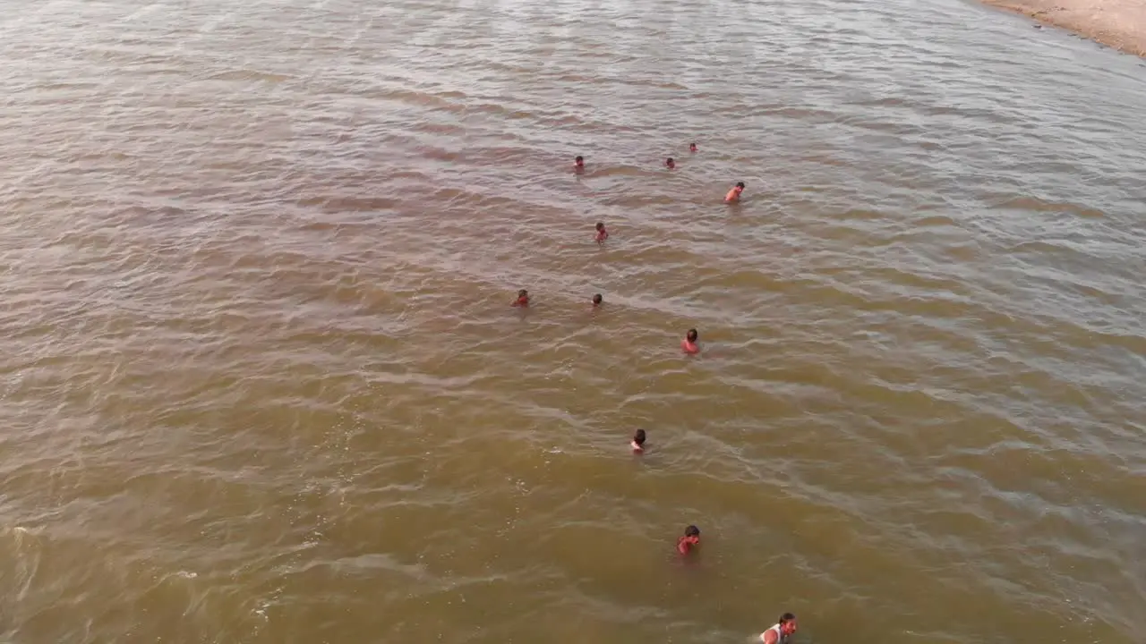 Aerial Circle Dolly View Of Male Rescuers Swimming For Flood Rescue Training In Balochistan