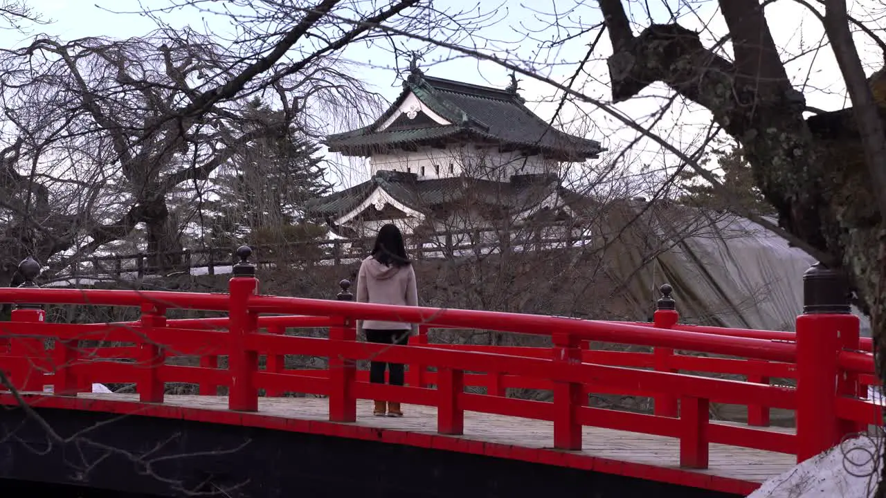 Stunning scenery in Northern Japan with female tourist looking out towards Hirosaki Castle