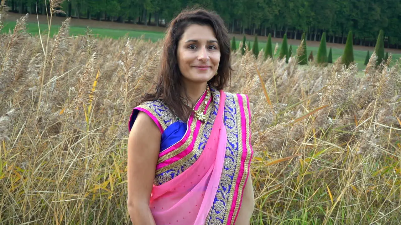 Beautiful girl looking at the camera in a wheat field