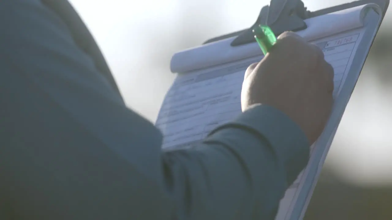 Female factory worker writing on document Colleague standing-by