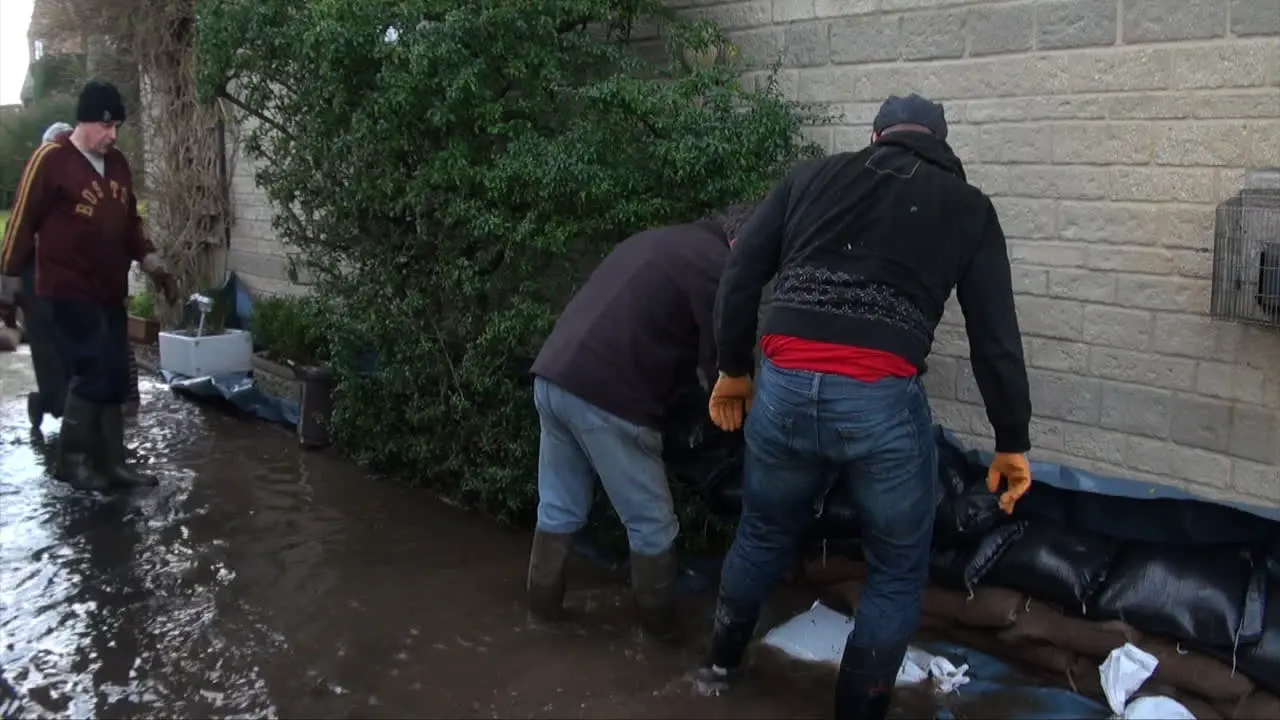 UK February 2014 Residents work together to build sandbag defences next to homes to halt rising floodwaters during the Somerset Levels flood