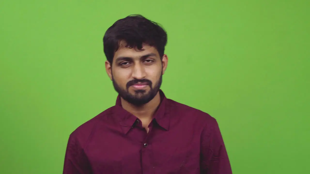 Man showing no no no sign while isolated on green screen