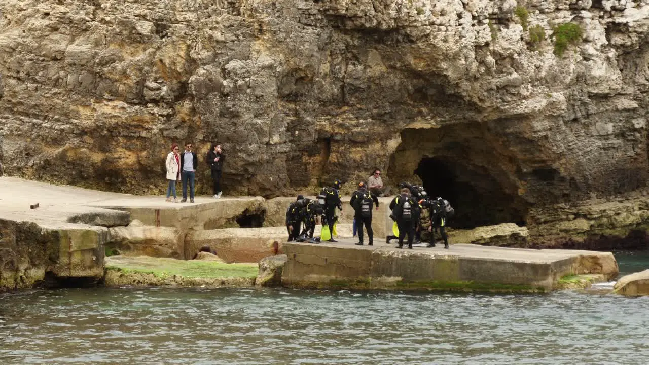 Group Of Divers Preparing For Diving In The Anchor Bay Shot From The Popeye Village