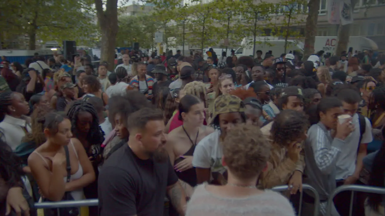 Crowd of people outside music festival queuing to enter in summer