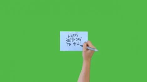 Woman Writing Happy Birthday to You on Paper with Green Screen