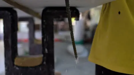 Handheld Close Up Shot of Saw Cutting Through Polystyrene Surfboard