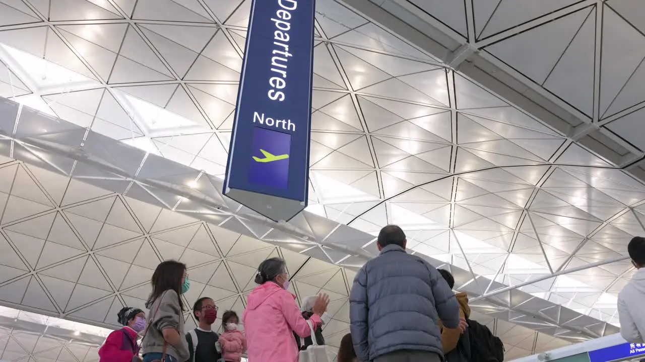 Flight passengers go through the departure hall at Hong Kong's Chek Lap Kok International Airport