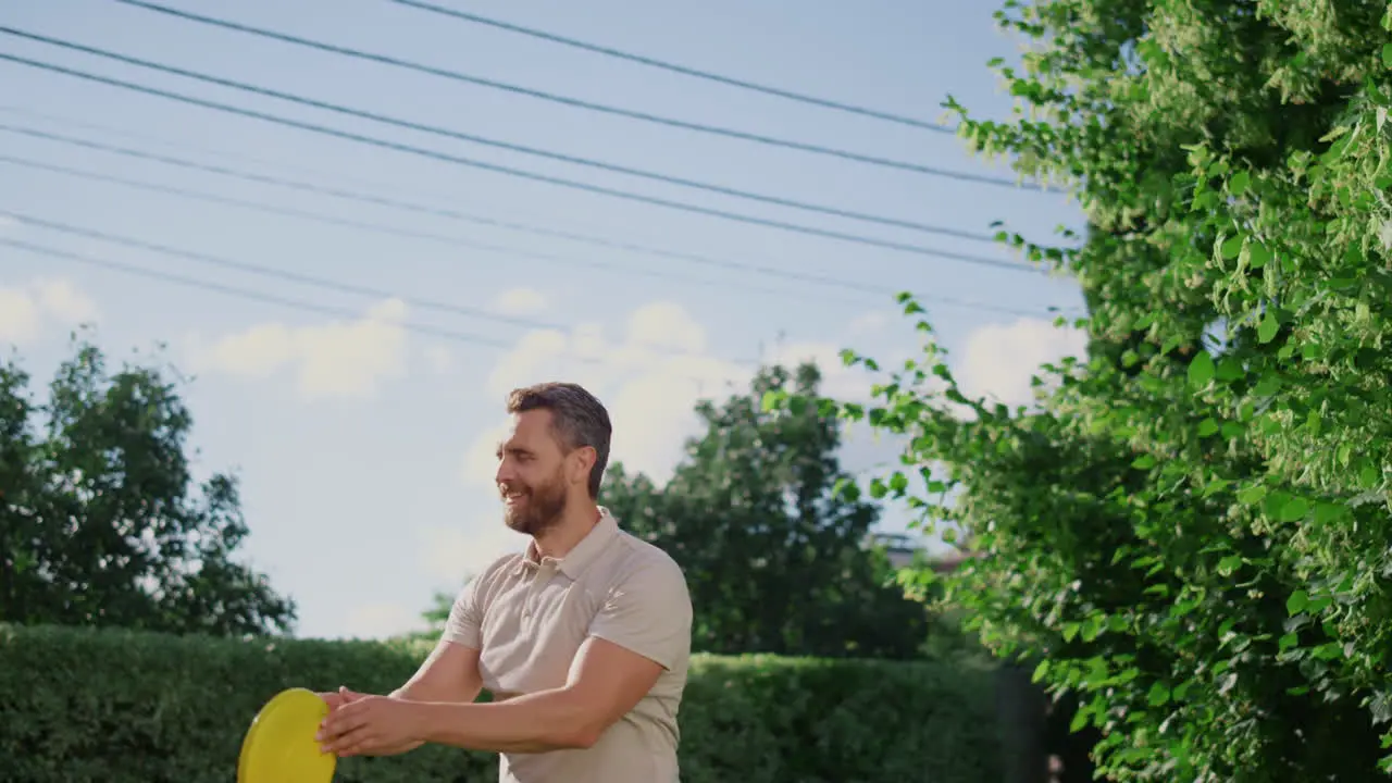 Smiling woman throwing flying disc on backyard