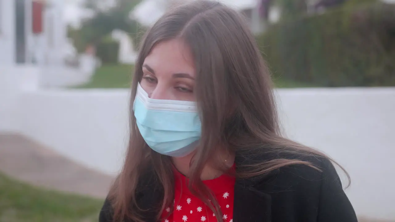 Girl wearing a surgical mask while looking at the camera