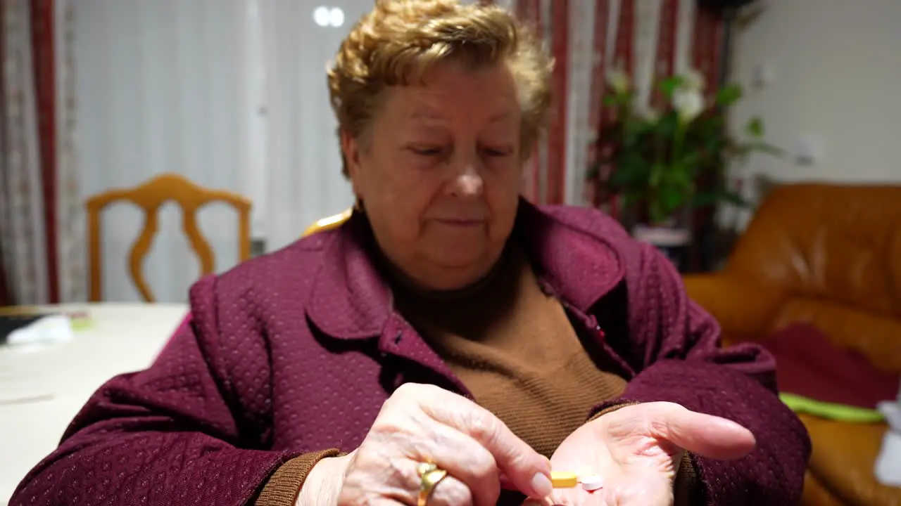 Elderly woman sorting medication at home