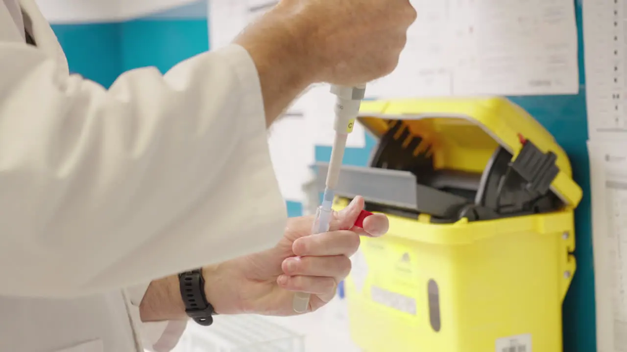 Close Up Of Scientist In White Lab Coat Pipetting In Test Tube In Medical Research Laboratory 4K