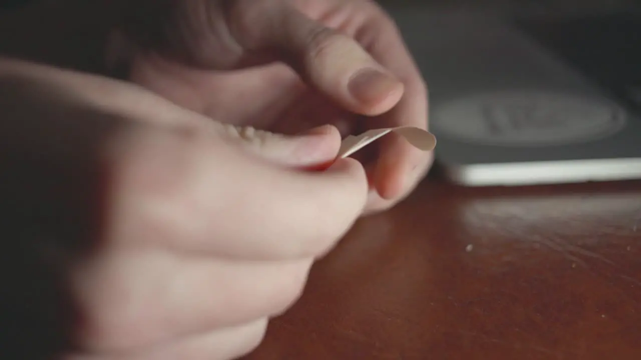 Woman's Hand Removing The Plastic Tapes Of The Bandage Closeup Shot