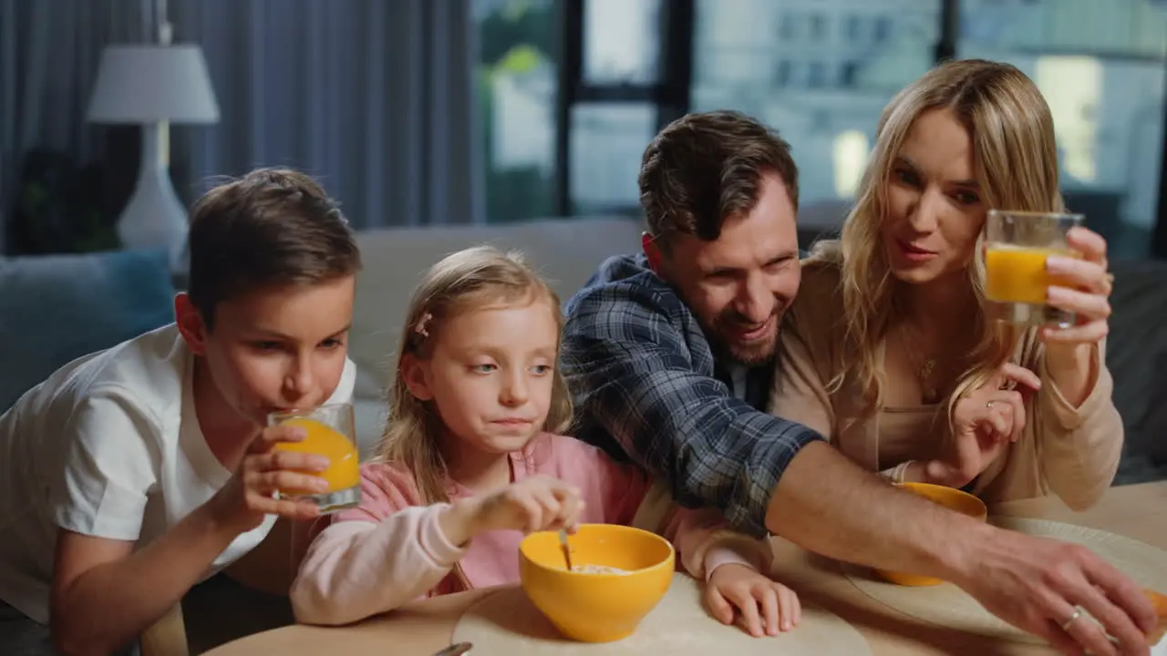 Family having breakfast in front of laptop Nice people making video call home