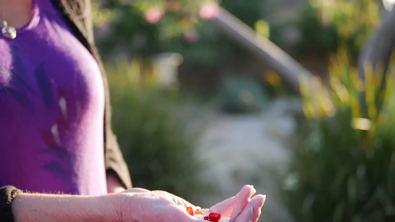 The hands of an old woman tossing prescription drug pills and medicine into the air in slow motion