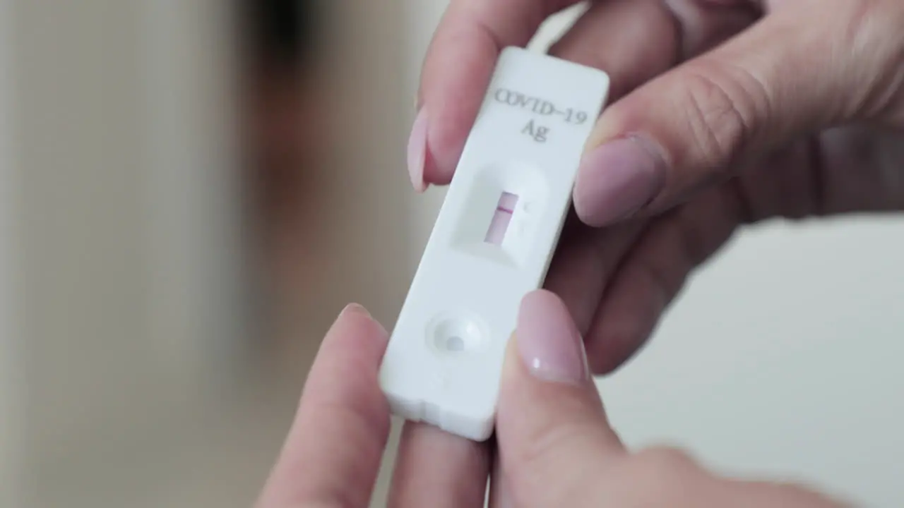 Girl Holding Rapid Diagnostic Test Kit Showing Negative Line Result For COVID-19