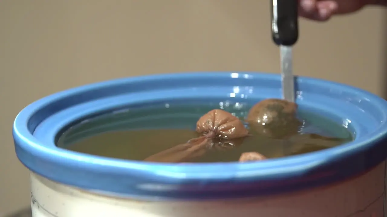 Stirring the coconut oil to aid with the extraction of CBD from the cannabis buds