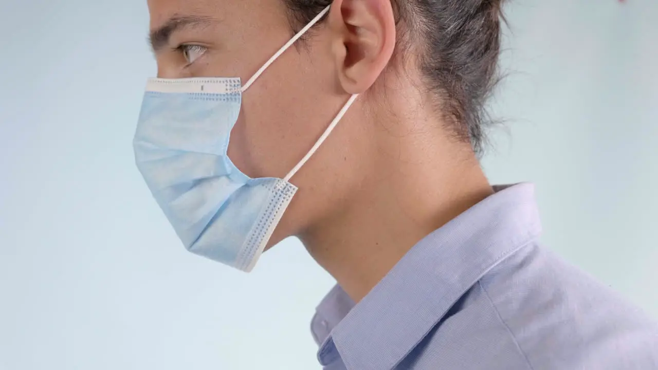 Man Putting on Disposable Surgical Face Mask Extreme Closeup Profile