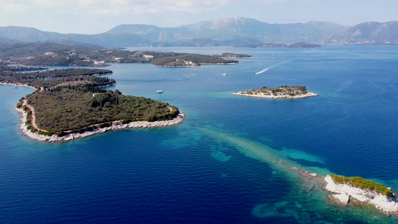 Meganisi Island Lefkas Greece Aerial Drone View of Boats Jetski Mountains and Blue Sea