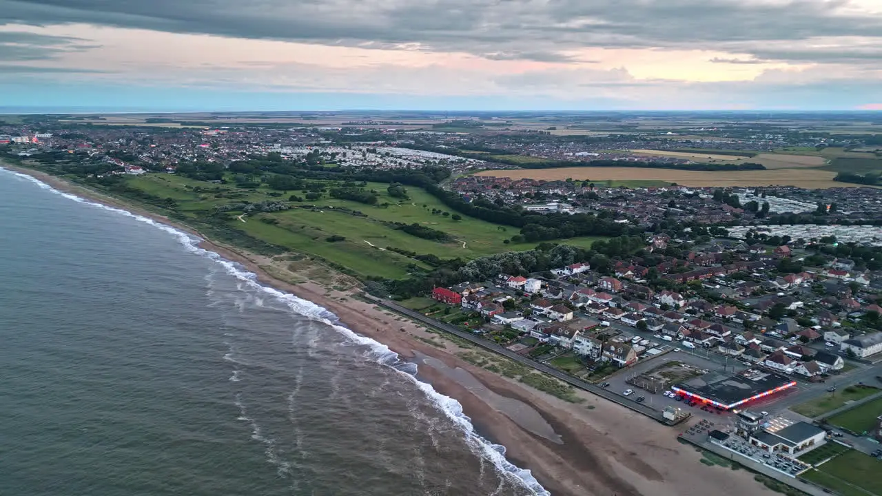 Enjoy aerial drone shots of Skegness town by the sea at sunset showcasing holiday park beach and caravans