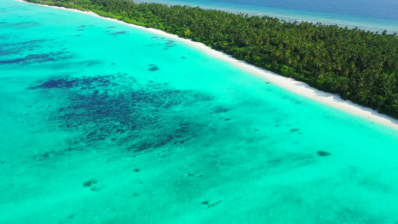 Bright wide turquoise lagoon with wonderful pattern of coral reefs around tropical island with lush vegetation in Atlantic ocean copy space