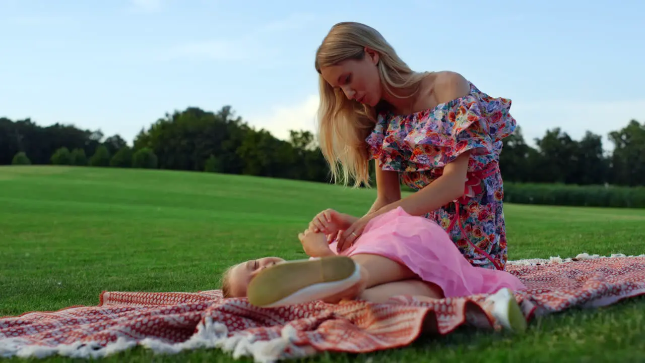 Joyful family playing at meadow Mother and daughter having fun outdoor