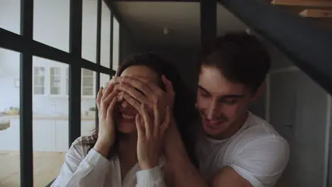 Happy family couple entering home in slow motion Portrait of hugging couple