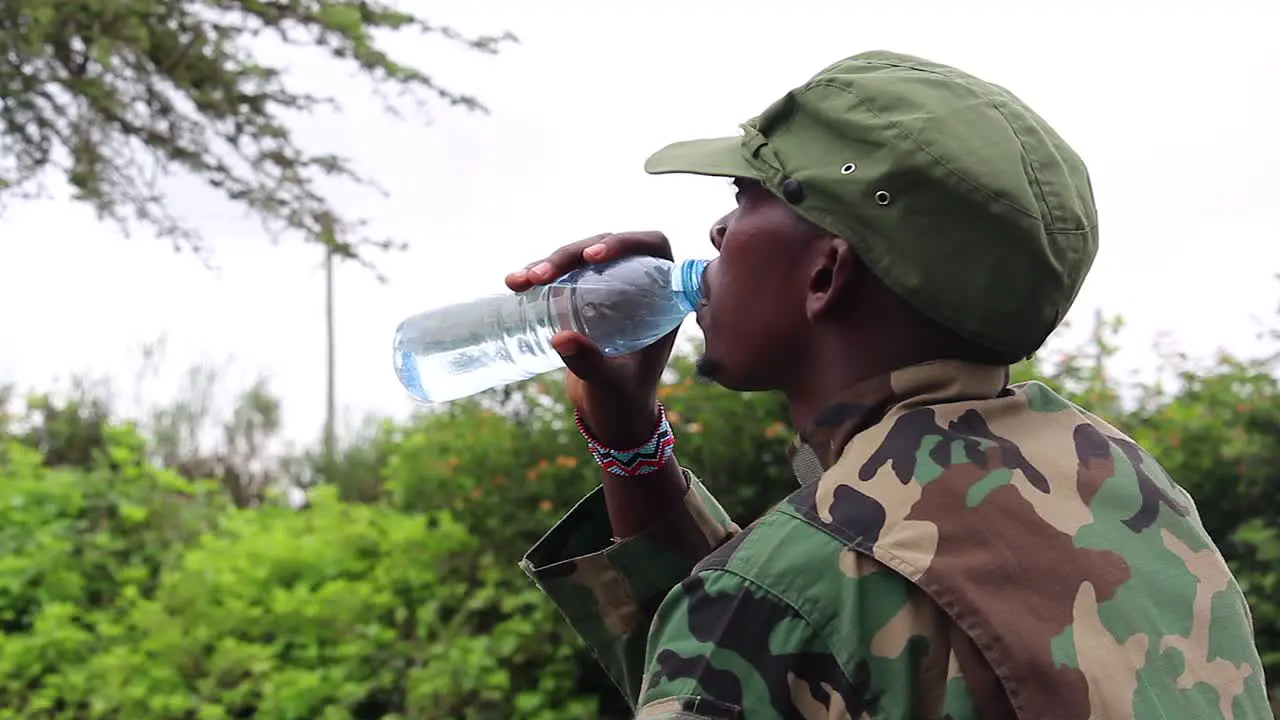 African militant geurilla sipping warter on hot day