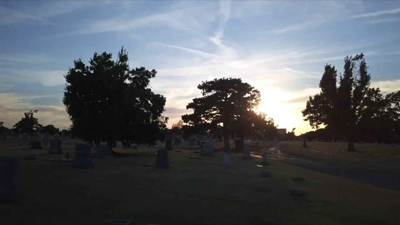 Low aerial dolly through the cemetery with dying light