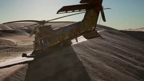 old rusted military helicopter in the desert at sunset