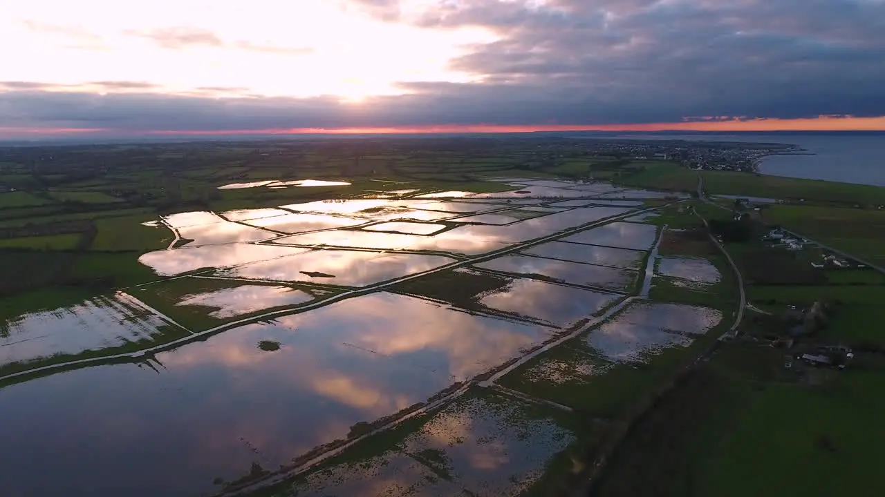 Sunset reflection on flooded fields Normandy coastline WW2 site Aerial drone