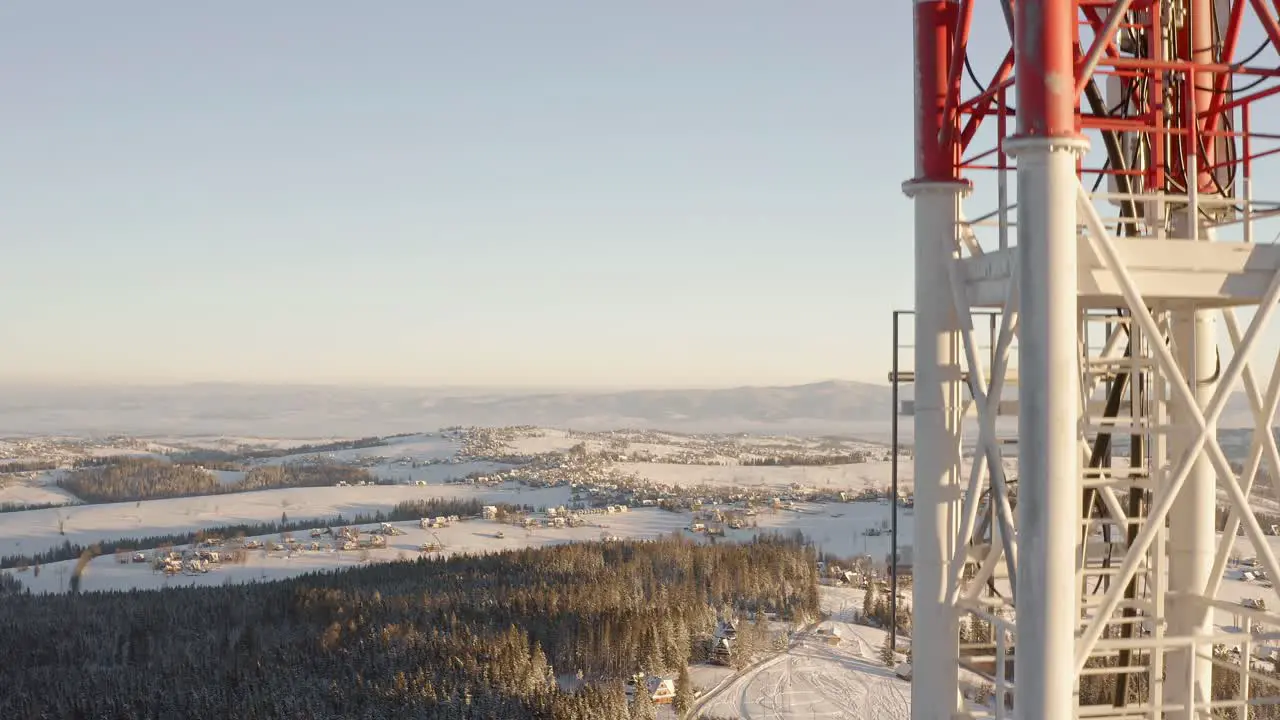 Aerial rising beside tall communication tower telephone connection pole