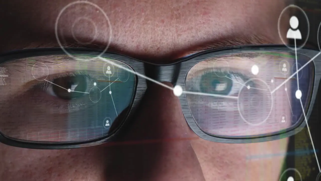 Man works on a global network and sorts the connections Screen is reflected in his glasses Close-up