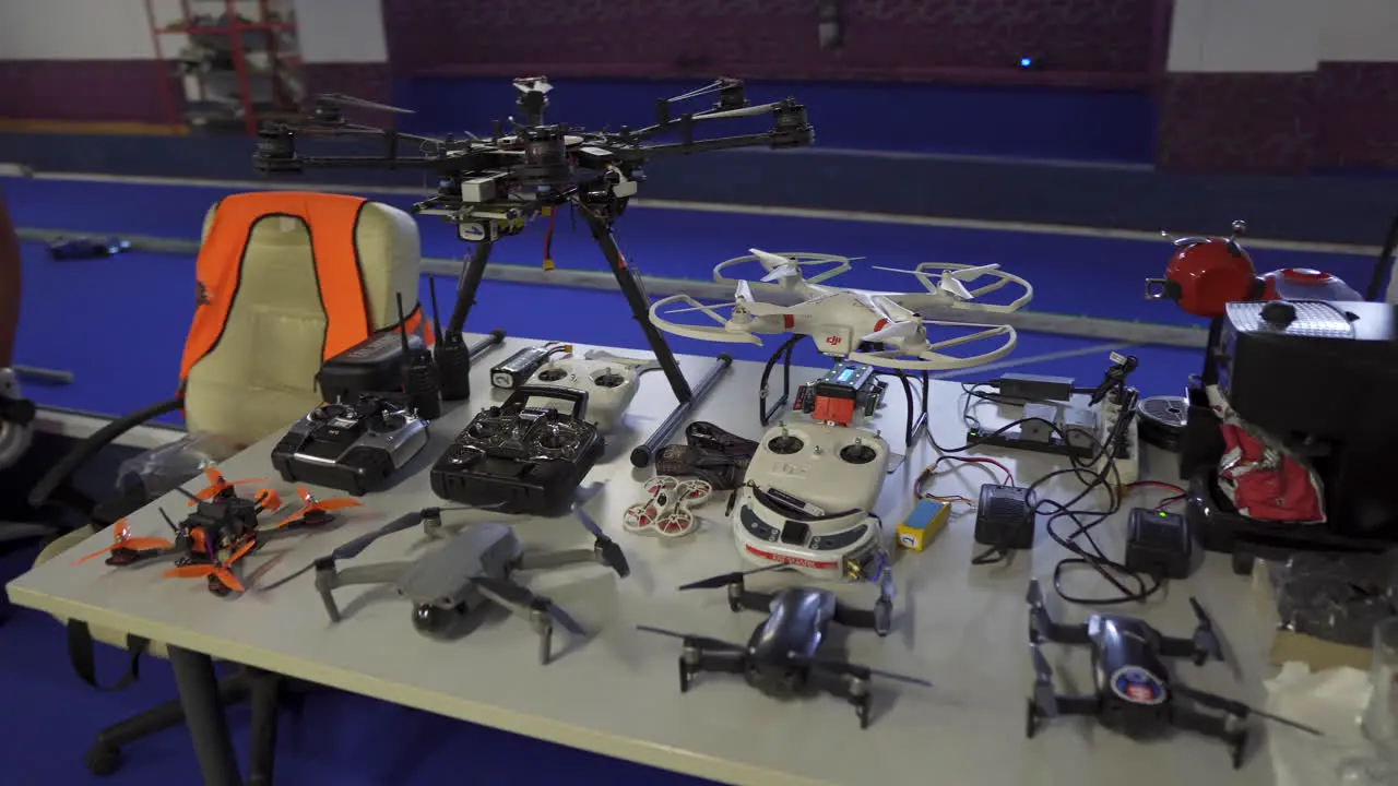 Drones and UAV aircraft neatly organised on a bench indoors at vocational high school