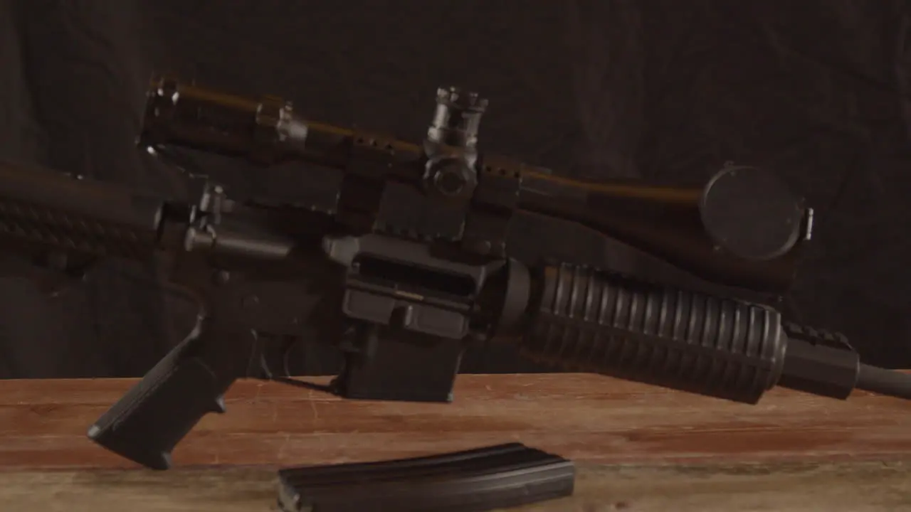 Dolly in of unloaded AR-15 on a wooden surface