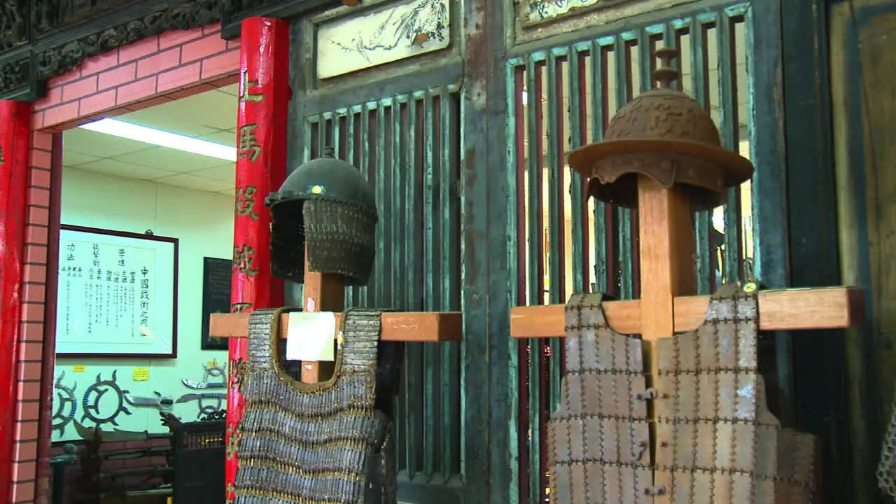 Panning of Chinese armor and helmets row soldiers equipment war museum Close up