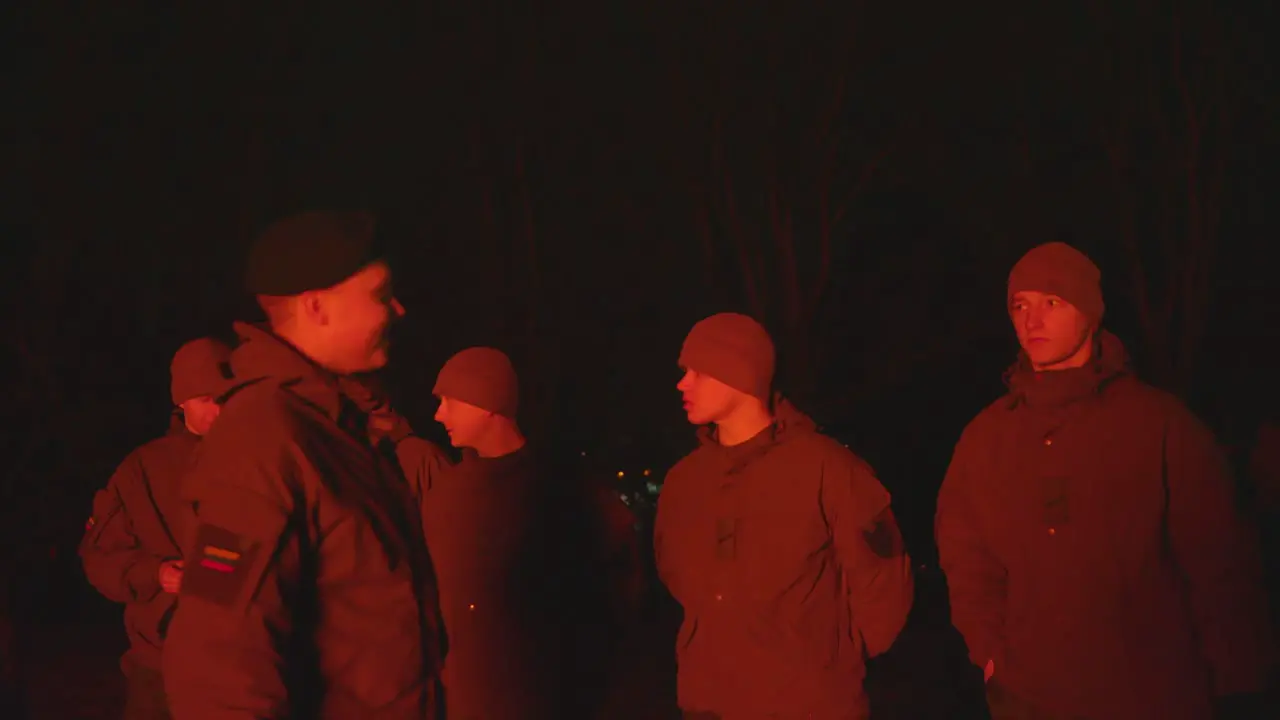 Group of conscripted soldiers in firelight at Lithuanian Independence Restoration Day