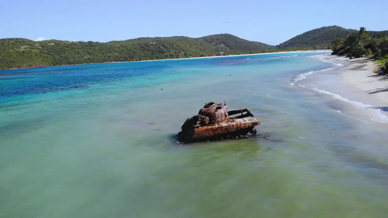 Old Tank in the ocean while waves crash in a beautiful beach setting