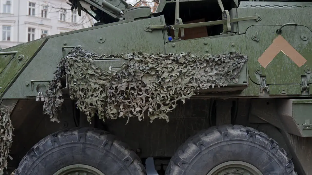 Armored vehicle with camouflage in downtown Riga tilt up view