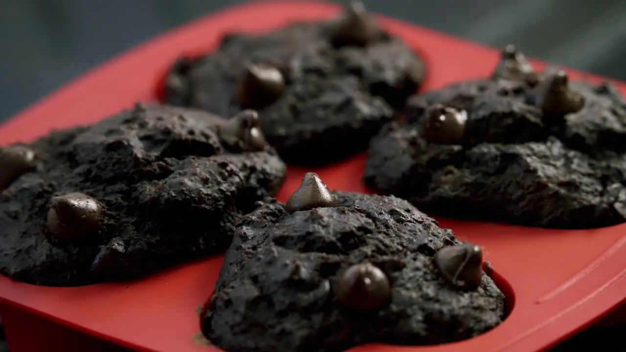 Slow zoom in of chocolate chip beetroot muffins in red silicone pan valentine's day