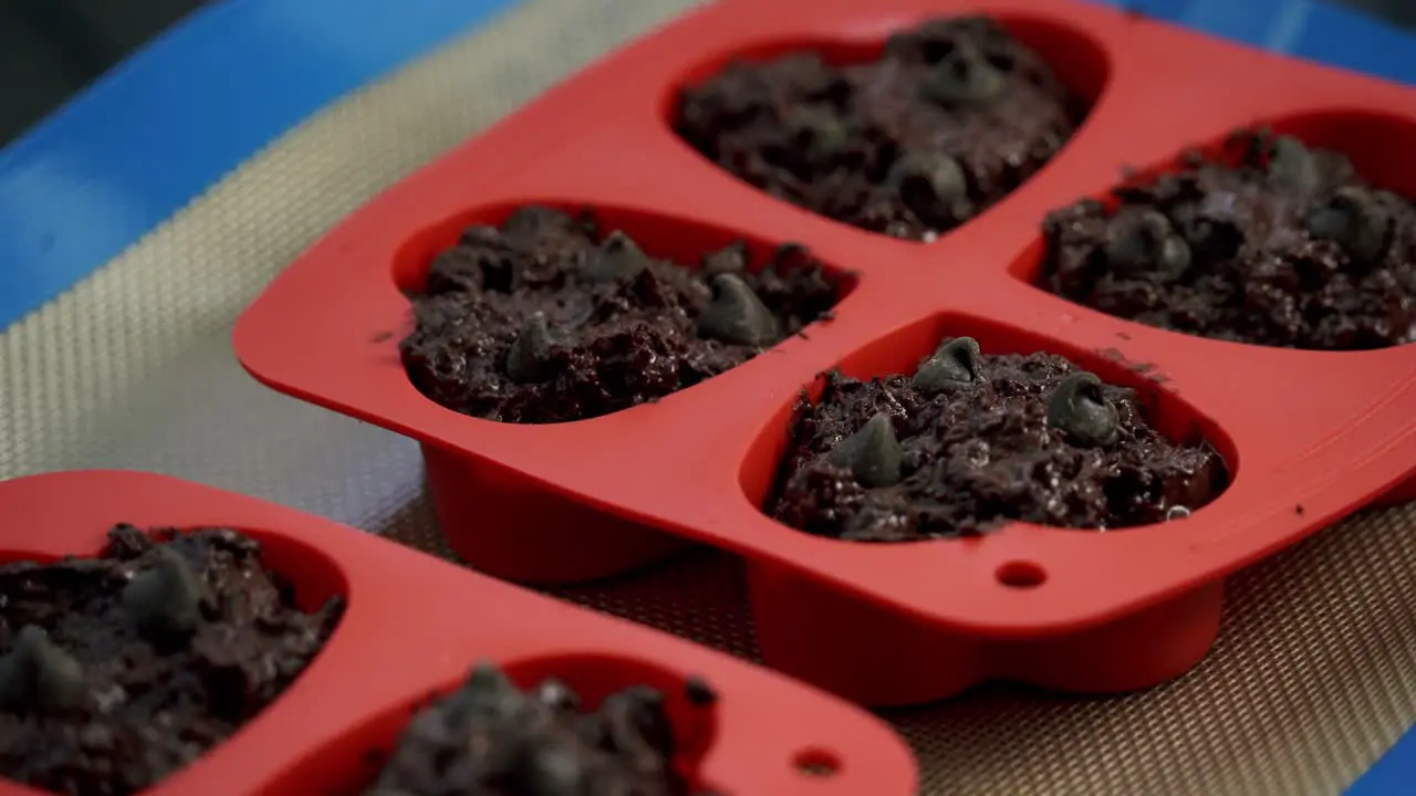 Close up of chocolate beets muffins inside of baking tray for valentines day candy heart love