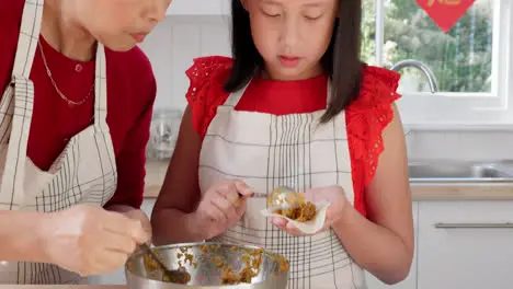 Mother teaching child to cook food in the kitchen