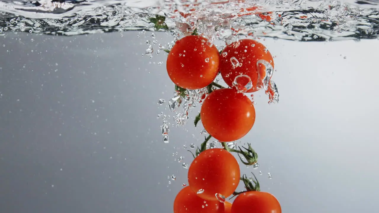 Underwater shot of vine tomatoes dipped into boiling water