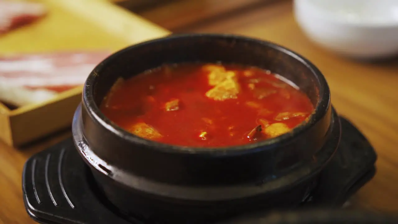 Kimchi Stew Kimchi-jjigae Served In Ttukbaegi In A Korean Restaurant