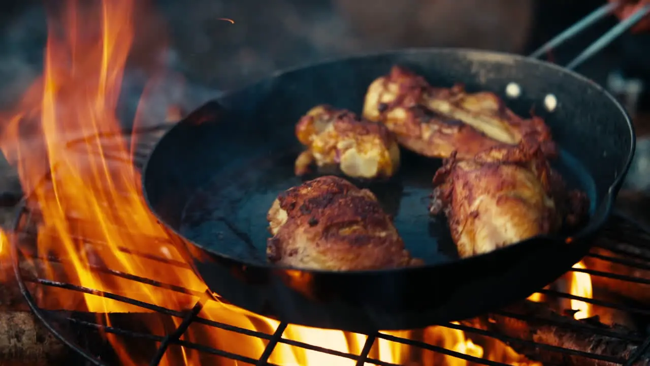 Cooking chicken over a campfire